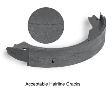 Brake shoe with acceptable hairline cracks in bonded lining and a magnified detail.